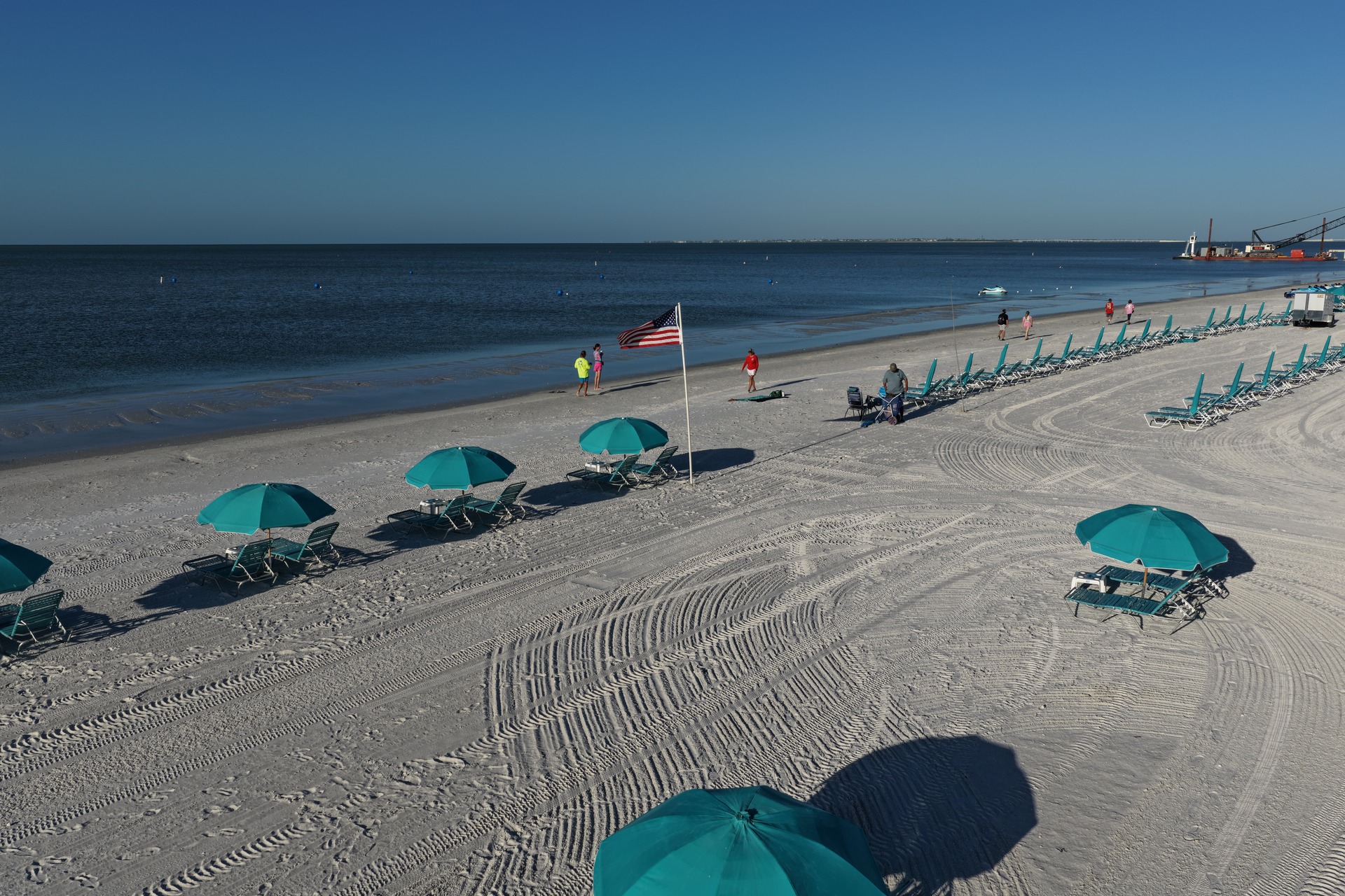 Turquoise beach umbrellas and shoreline at Fort Myers Beach